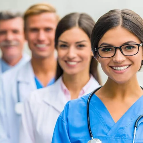 Doctors and Nurses smiling in a row