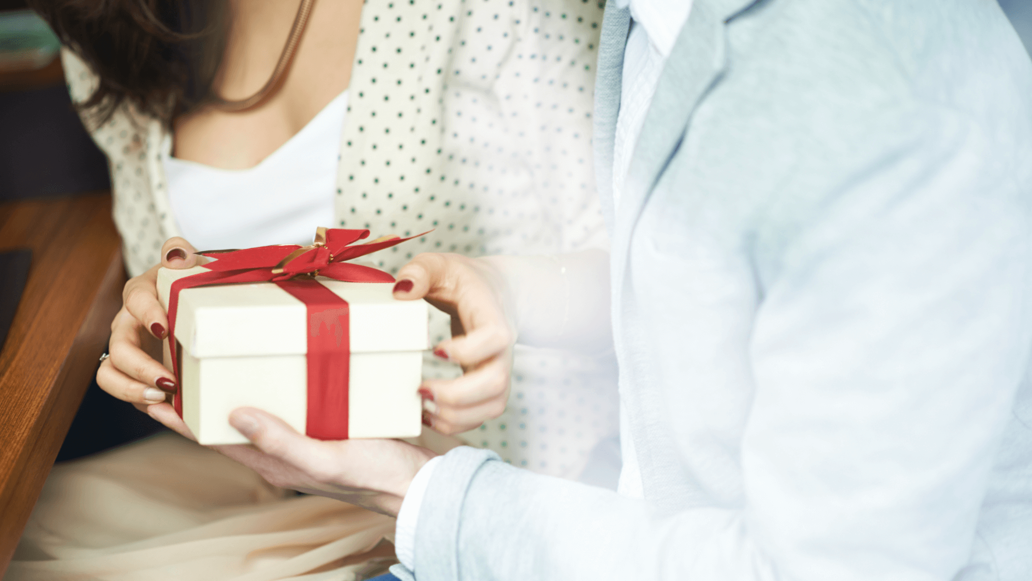 two people holding a gift box