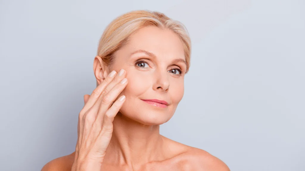 woman applying skin care product to face